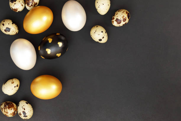 istock Gold, black and white Easter eggs on a dark gray background. 1456871278