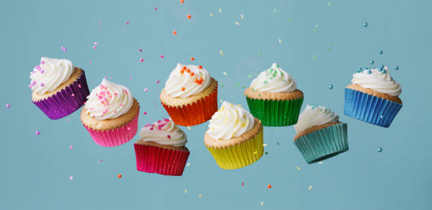 istock Banner with row of colorful cupcakes and falling sprinkles 1456871325