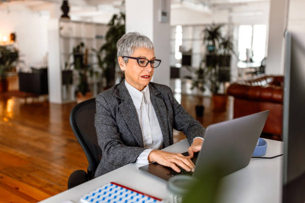 istock Mature businesswoman working at office desk 1456871439
