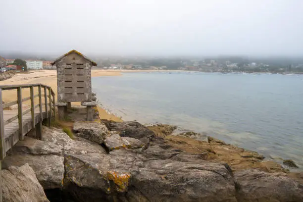 The Aldan Estuary cannot be considered estuary because it is not formed by the mouth of the river, but we can say that it is a deep entree of great beauty of the Pontevedra Estuary in Galicia Spain Stone horreo building.