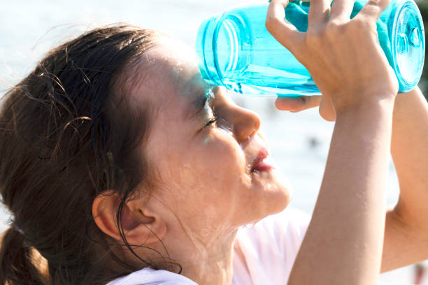 istock Little Girl Pouring Water On Herself 1456873522