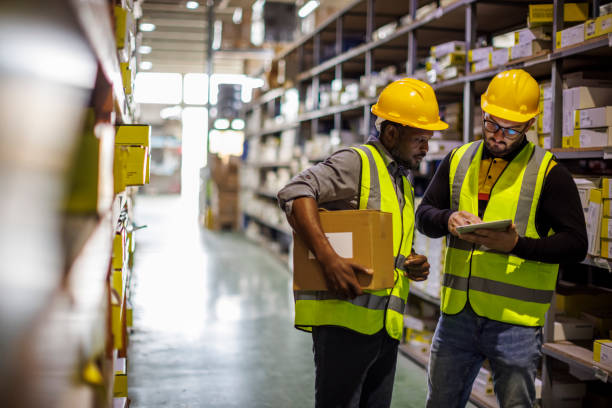 istock Two warehouse workers walking in distribution storage area discussing about logistics and organization 1456873737