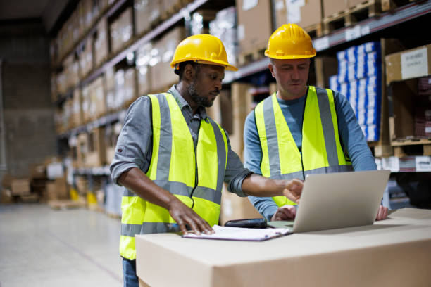 istock Two warehouse workers discussing about logistics and organization in distribution storage area 1456875469