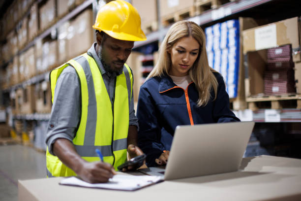 istock Two warehouse workers discussing about logistics and organization in distribution storage area 1456875470