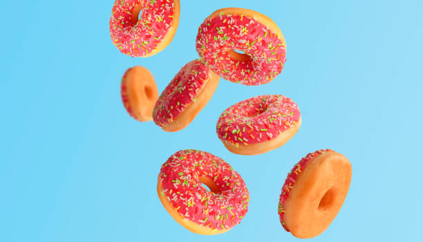 istock Flying delicious donuts on a blue background 1456875624