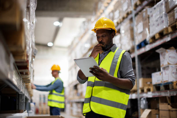 istock Worried warehouse employee using digital tablet in distribution storage area 1456875987