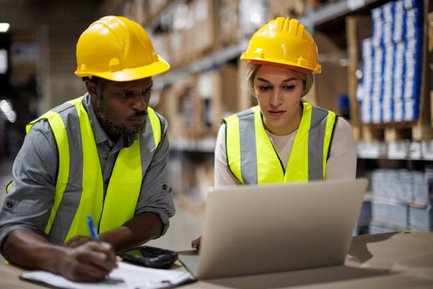 istock Two warehouse workers discussing about logistics and organization in distribution storage area 1456877732