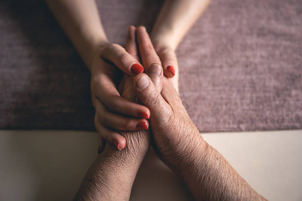 istock Old and young man holding hands, close up. 1456878059