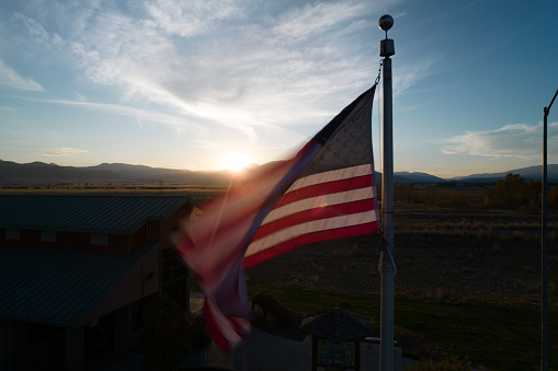 American flag on the background the sun and mountans in Montana