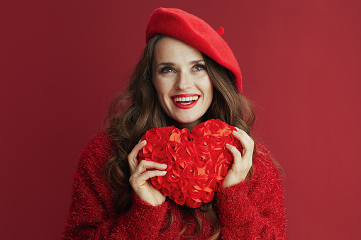 Happy Valentine. happy modern woman in red sweater and beret with red heart.