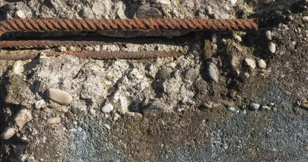 damaged reinforced concrete with exposed rusted steel resistance bars