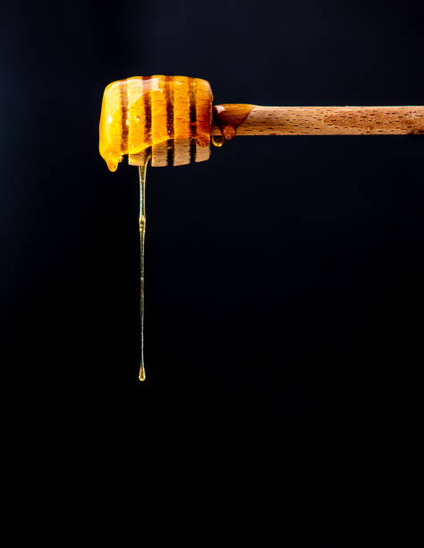 istock Sweet Honey Dripping from a Honey Dipper 1456886748