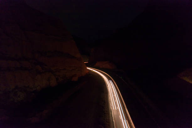 istock Traffic in highway through Mountani at night. 1456888509