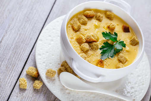 pumpkin cream soup on wooden background