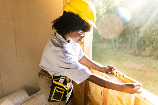 istock Construction trainee working in wooden house interior 1456889912