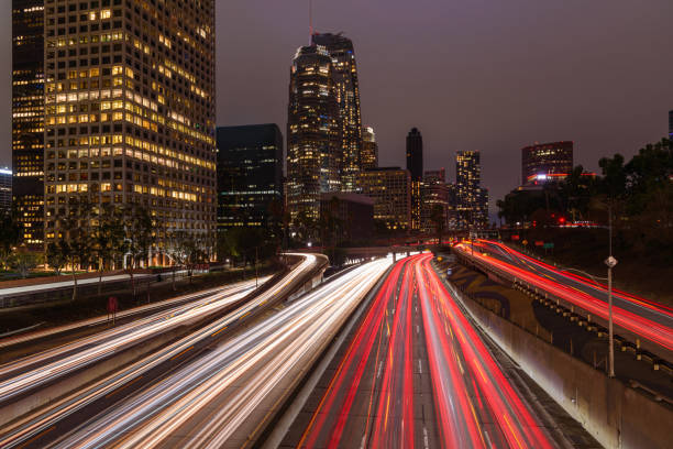 istock Los Angeles financial district skyline with traffic streaming along a freeway 1456890046