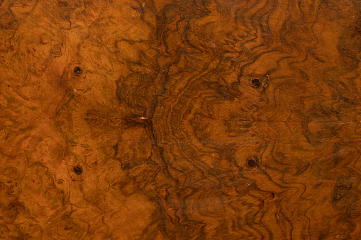 Textured wood veneer made from a walnut tree burl.
