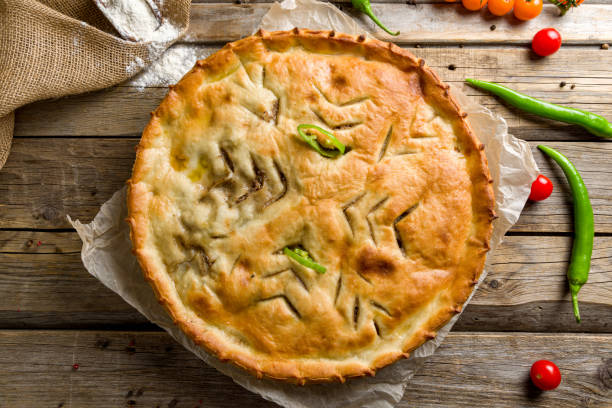 istock Ossetian pie with meat on old wooden table top view 1456891722