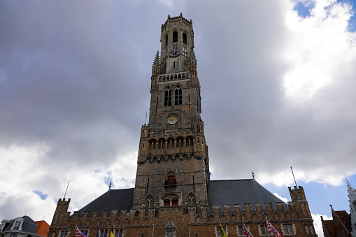 Bruges, Belgium - September 8, 2022: Impressive medieval building it is massive the Belfort van Brugge in front of which is a large square, not visible here.