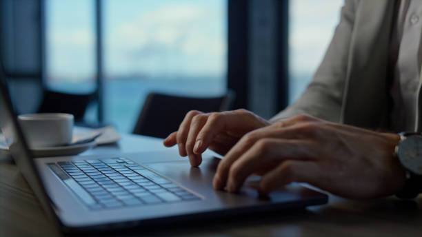 istock Unrecognizable businessman work on laptop at sea office. Man hands typing 1456893616