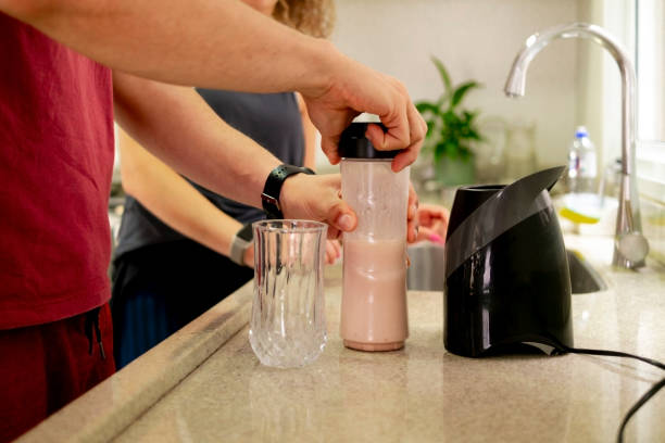 istock Young couple preparing beverages at home. 1456893761