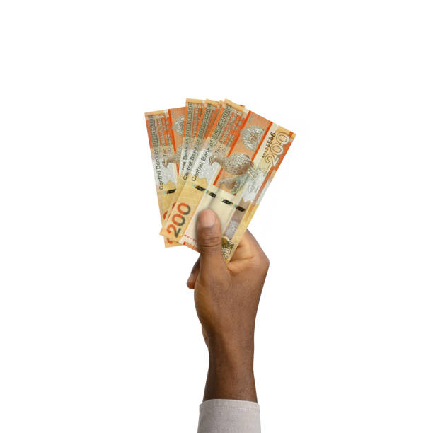 istock Black Hand holding 3D rendered Gambian dalasi notes 1456894455