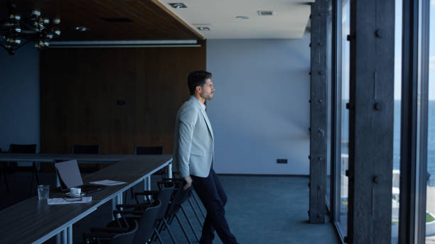 istock Man enjoying break conference room. Manager making pause and looking distance 1456895337