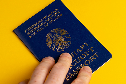 a blue Belarusian passport with inscriptions and a coat of arms, a close-up photo of a Belarusian citizen's passport
