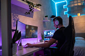 Teenage Boy Playing Multiplayer Games on Desktop in his Room