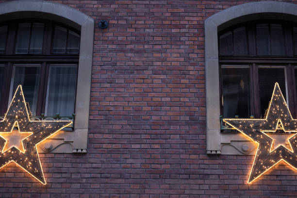 Several windows in a row on facade of urban apartment building front view, St. Petersburg, Russia.