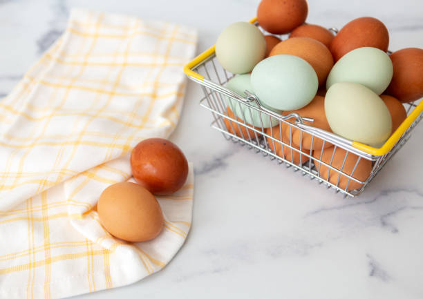 istock Wire Basket of Fresh Brown and Blue Chicken Eggs on White Counter 1456907287