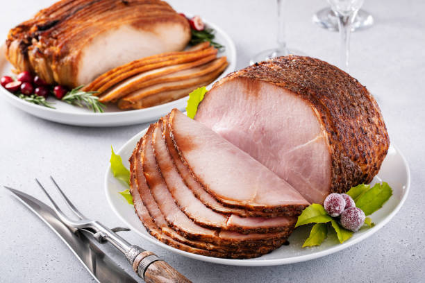 istock Christmas dinner main dishes, spiral sliced ham and roasted turkey breast 1456907313