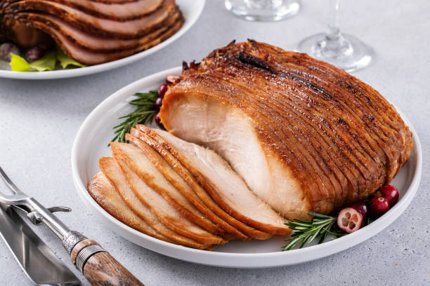 Christmas dinner main dishes, spiral sliced ham and roasted turkey breast Christmas dinner meat main dishes, honey glazed spiral sliced ham and roasted turkey breast for the holidays turkey breast stock pictures, royalty-free photos & images