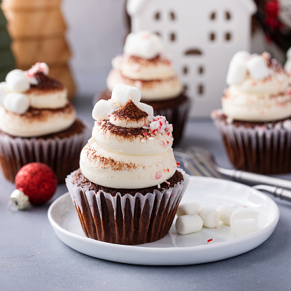 Hot chocolate cupcakes with whipped cream frosting topped with marshmallows and crushed candy cane, Christmas dessert idea
