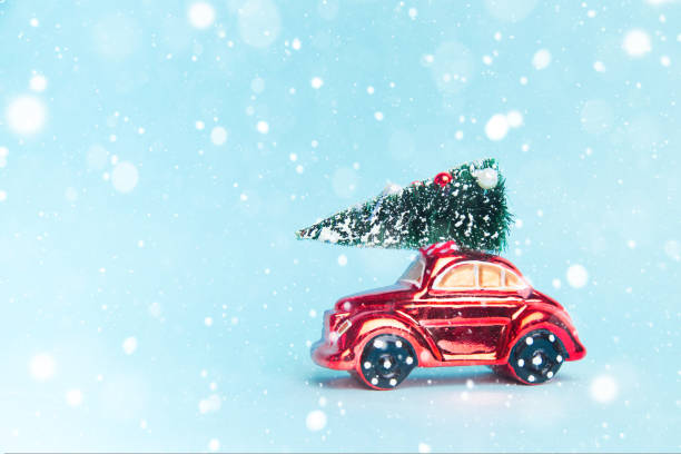 istock red car with a christmas tree and gifts on a blue background. 1456908123