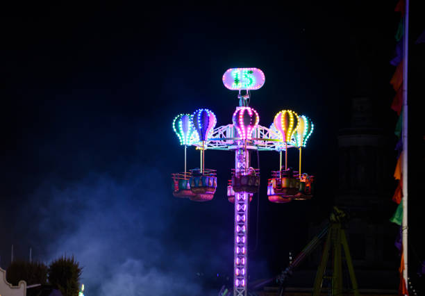 Breakdancer ride at the Schelmenmarkt autumn market in Gelnhausen downtown, Hesse, Germany. The ride with the breakdancer in full motion, rotating and spinning movement at once in two directions. Breathtaking speed combined with cool music and light show.
