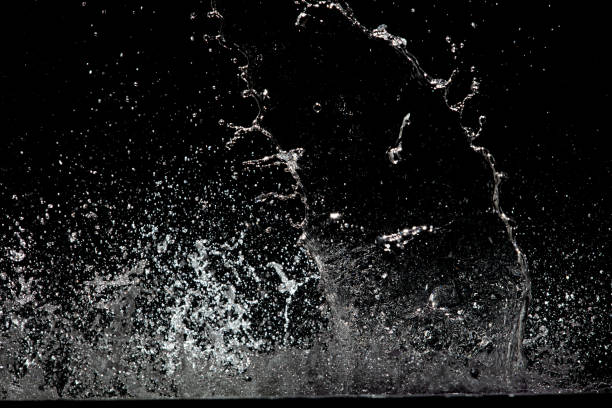 istock Blur Defocus Image of Water hit wall ground, explode into drop droplet. Amount Water attack impact and fluttering in air explosion. Stop motion freeze shot. Splash Water for texture elements 1456910301