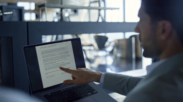 istock Manager pointing finger laptop closeup. Director talking to unknown partner 1456910385