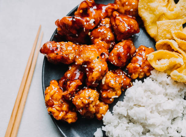 istock Close up of general tso's chicken with white rice and crab rangoon 1456912626