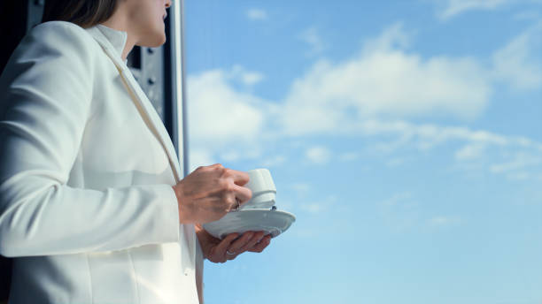 Portrait businesswoman drinking coffee on cloudy sky view. Woman taking break