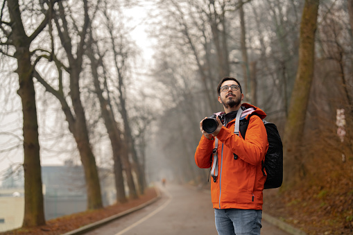 Traveller taking photograph with a mirrorless camera