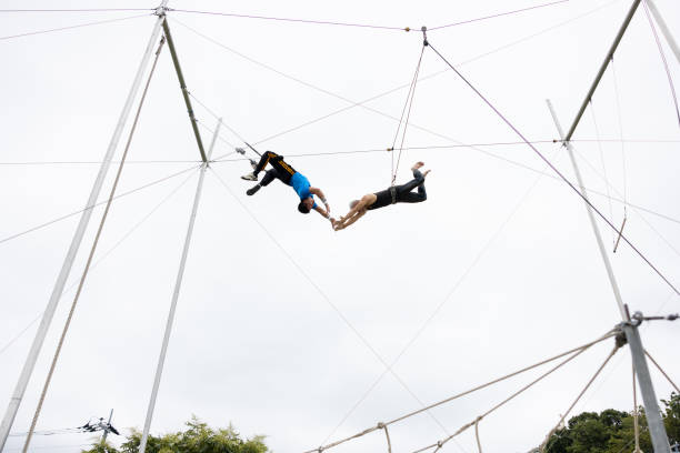 istock Two trapeze artists flying together - catching 1456922042