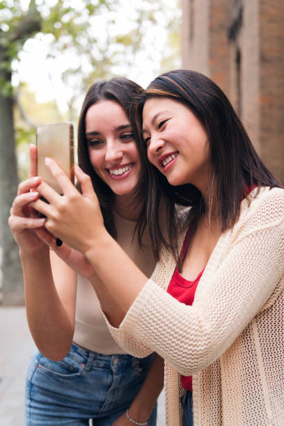 istock women smiling happy looking content on at phone 1456922853