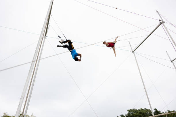 istock Two trapeze artist flying together in the sky 1456923287