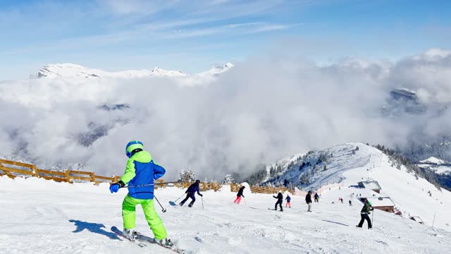 Child ski fast downhill over beautiful Mont Blanc mountains