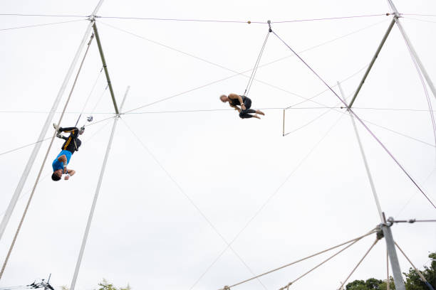 istock Two trapeze artists flying together 1456923503