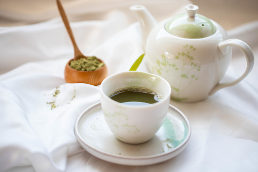 warm green tea on white cloth