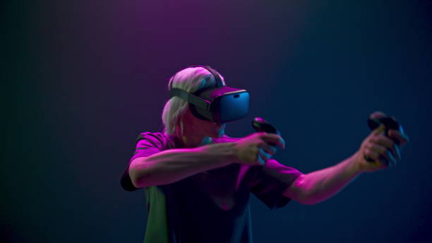 istock Emotional man playing shooter using joysticks closeup. Gamer hitting target 1456932163