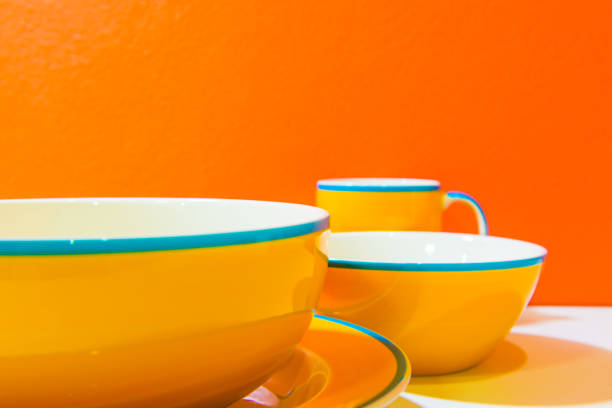 istock Plate, bowls and cups with orange wall and white floor 1456934450
