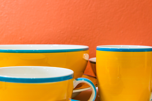 Bowl and cups with orange wall, Thailand.